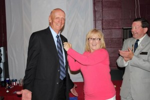 Don Lynam receives 35 year service numeral from Division Director Bev Sewell as Immediate Past District President Larry Sewell looks on