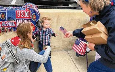 Exchange Distributes Flags at Memorial Day Parade